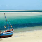 A Dhow at the water's edge on a beach in Mozambique